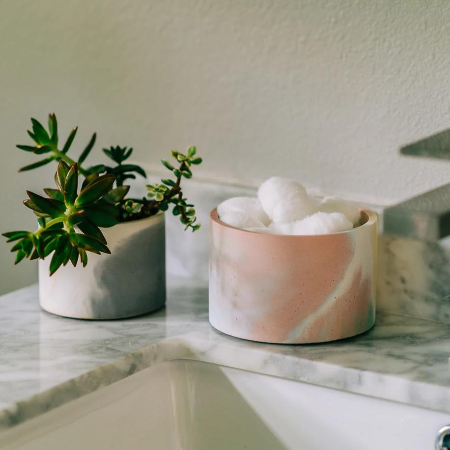 5 inch concrete vessel in jawbreaker (rainbow color) with cotton balls in bathroom.