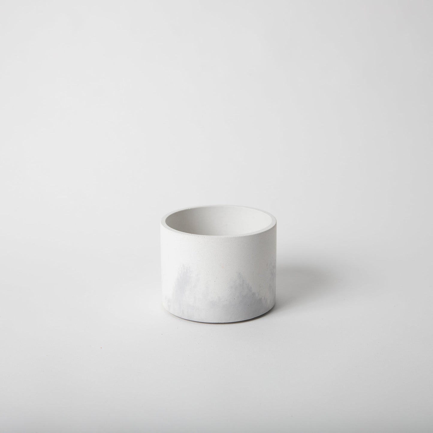 4 inch concrete vessel with cork base in white and grey.