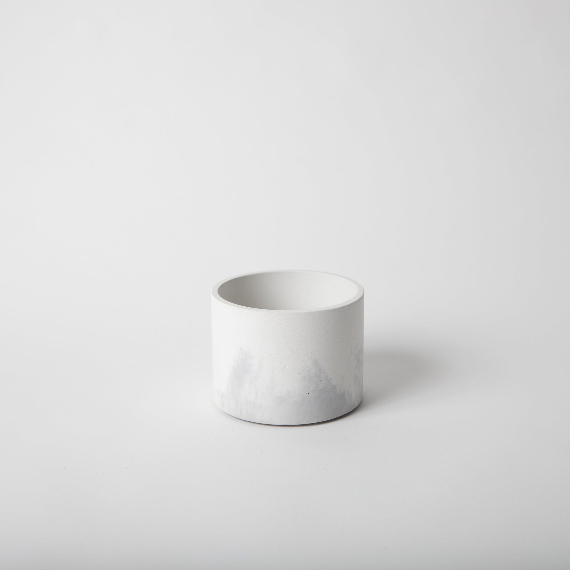 4 inch concrete vessel with cork base in white and grey.