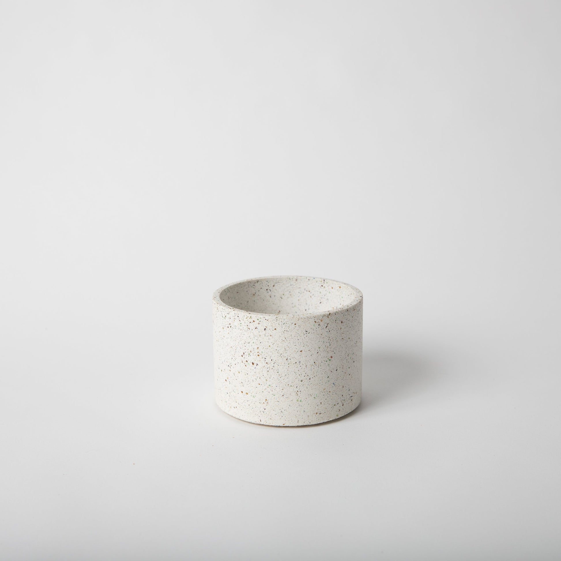 4 inch concrete vessel with cork base in white terrazzo.