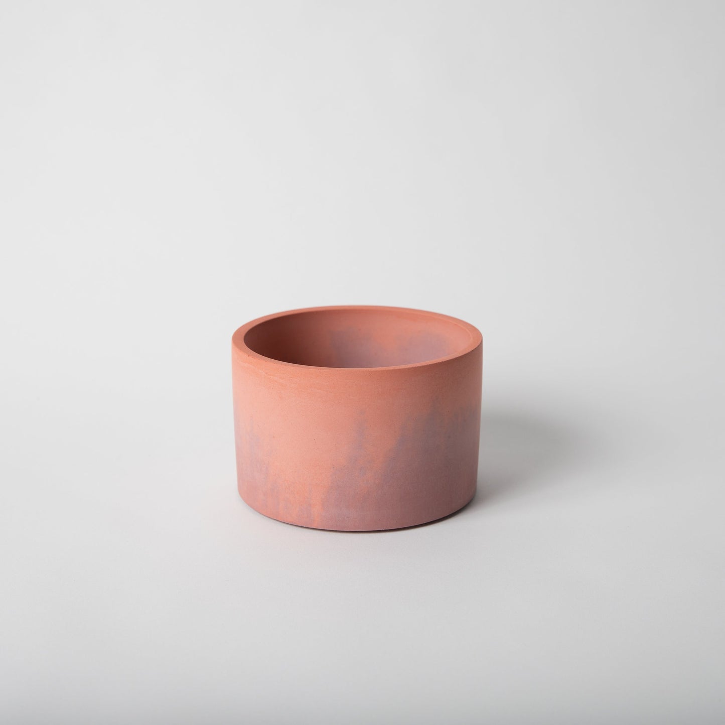 5 inch concrete vessel in coral and mauve.