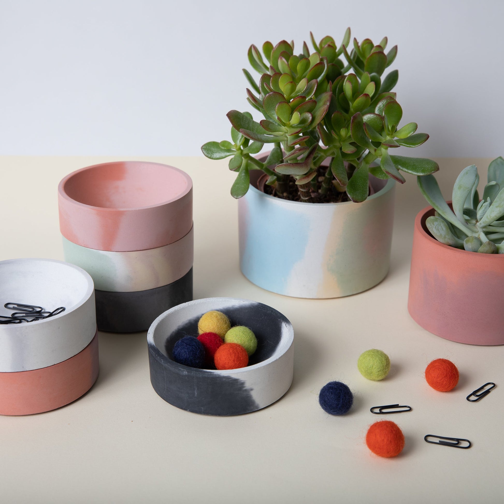 5 inch concrete vessel in group shot with catch alls showing objects in use.