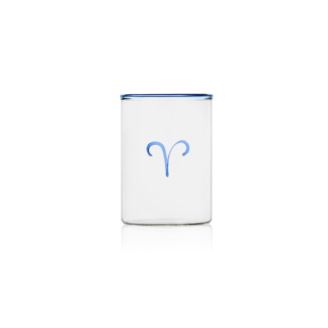 This handblown clear glass tumbler with royal blue rim and Aries sign on the outside in cobalt blue glass brings just the right amount of colour to the table. The perfect white elephant gift under $50