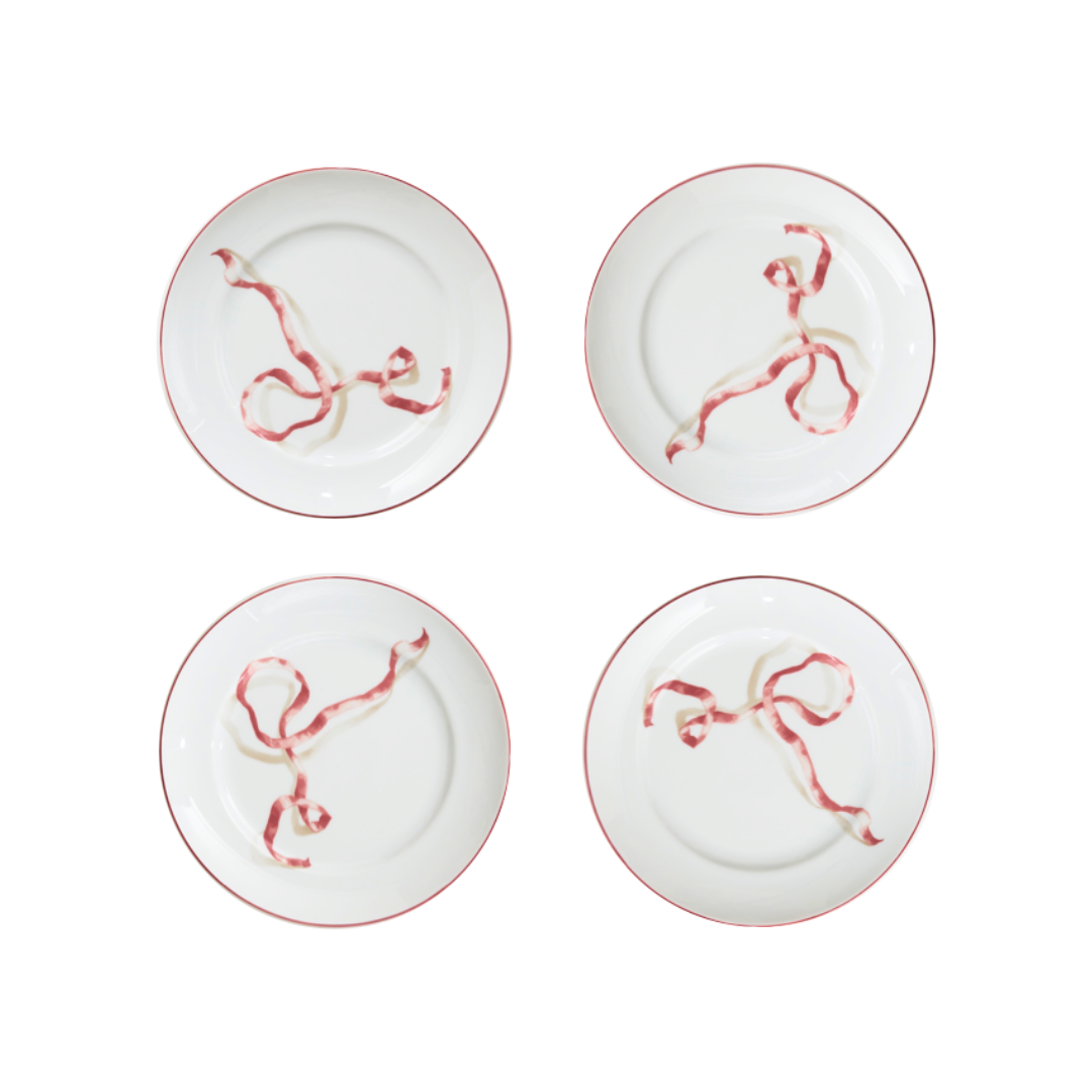 A set of four ribbon dessert plates in pink. Harper’s Bazaar Best Hostess Gifts for Dinner Parties, Movie Nights, and More. These ribbon-adorned dinner plates can transform even an easy meal into something fit for a downtown It-girl. With three different colors to choose from, you can find the perfect option for home design lovers.